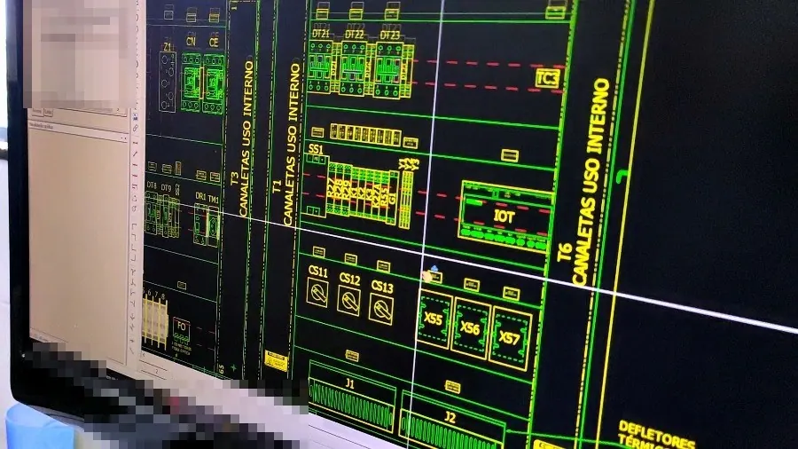 Monitor showing EPLAN Electric P8 open on a panel layout drawing, with wiring ducts, terminal blocks, and labeled devices